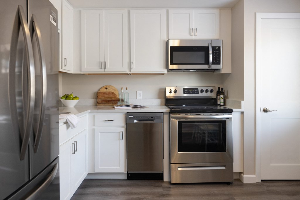 Kitchen with white cabinets and a stainless steel appliances at 151 Ocean Road LLC, Narragansett, RI, 02882