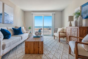 Living room with large glass doors and a carpeted floor at 151 Ocean Road LLC, Narragansett, RI, 02882