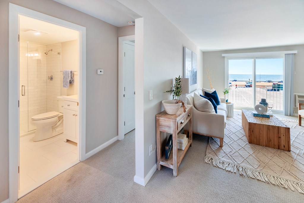 Carpeted living room with wide windows at 151 Ocean Road LLC, Narragansett, RI, Rhode , 02882