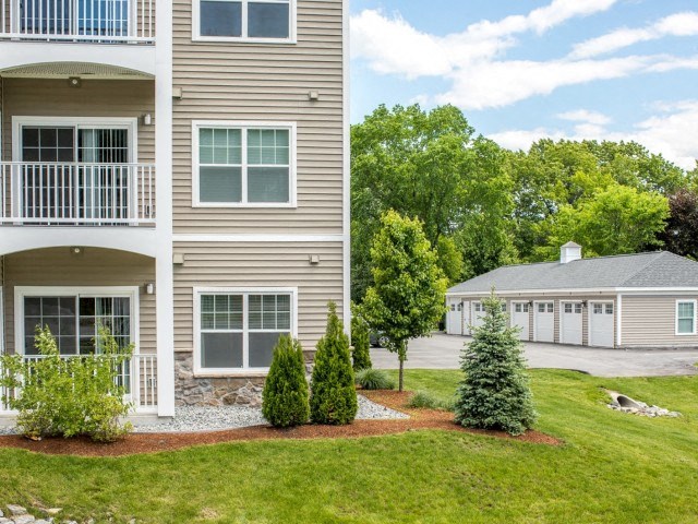 Village green apartment building with garage parking