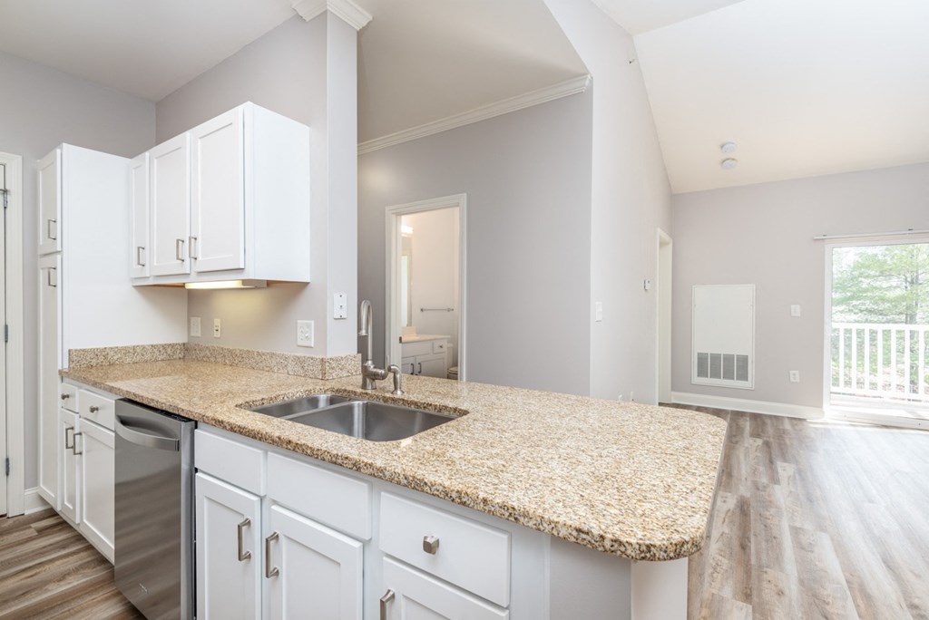 Drum Hill 2 Bedroom Apartment Kitchen with granite countertops, white cabinetry and large family room