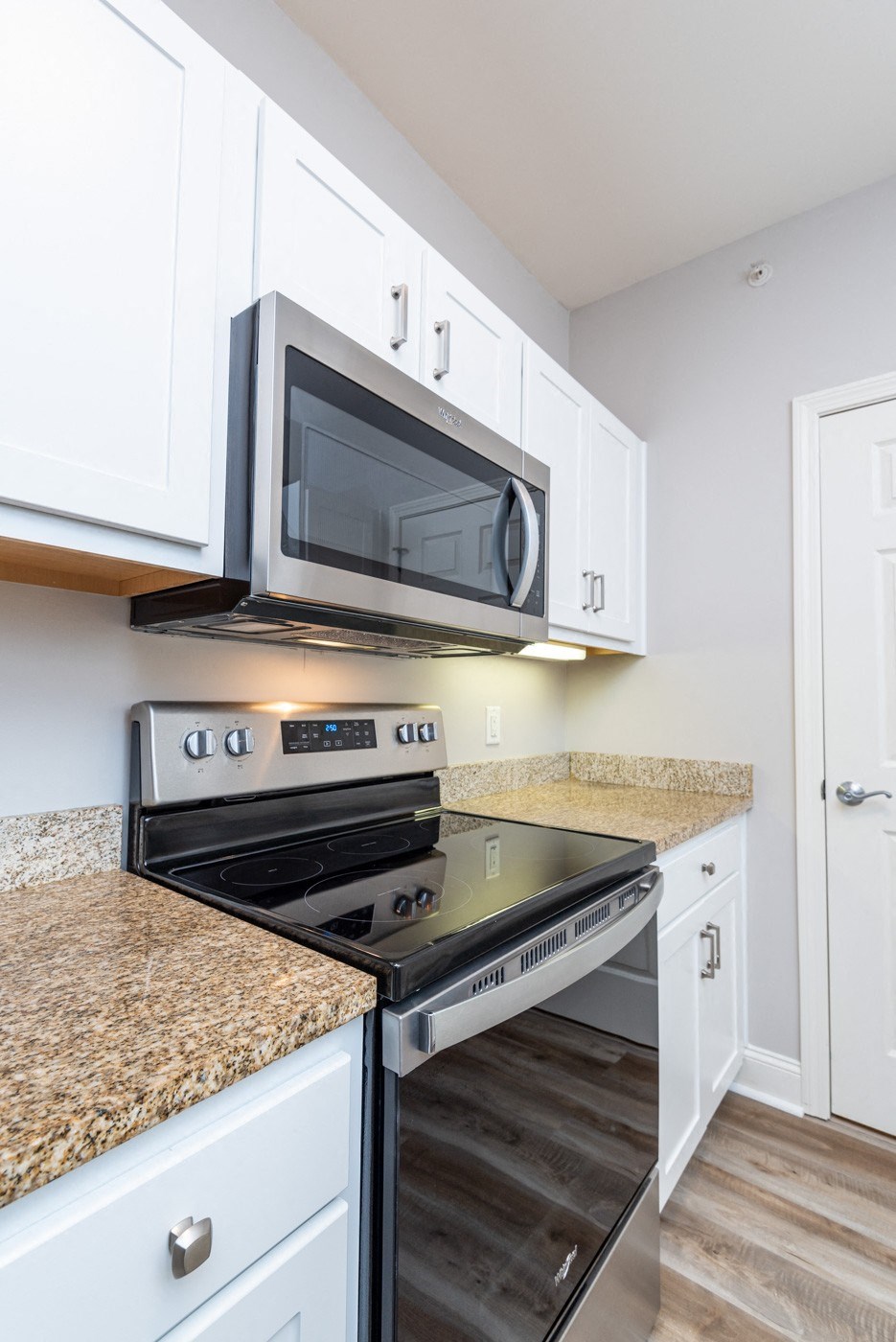 Drum Hill 2 Bedroom Apartment Kitchen with stainless steel range and microwave, granite counters