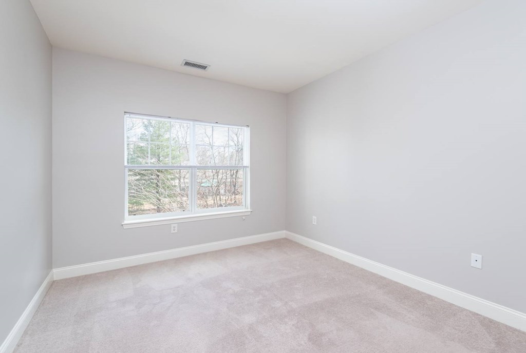 Drum Hill 2 Bedroom Apartment bedroom, with plush carpeting and large windows