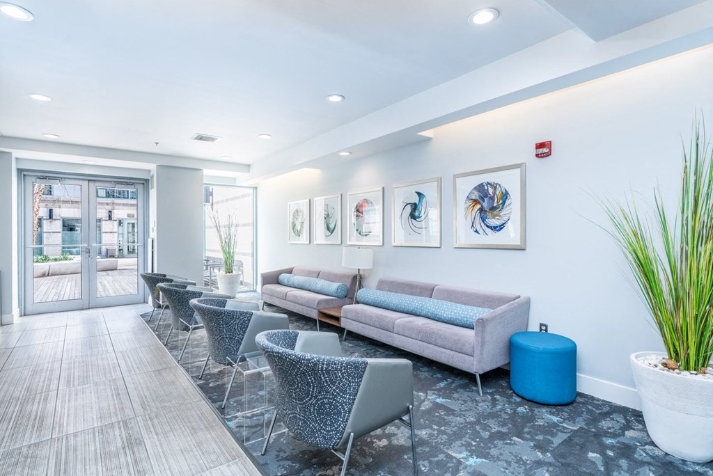 with couches and chairs and a lobby area with paintings