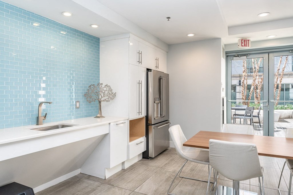 50 WB community space with a kitchen and dining area with a table and chairs