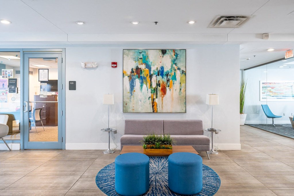 50 WB's leasing office lobby with a couch and a coffee table and a painting on the wall