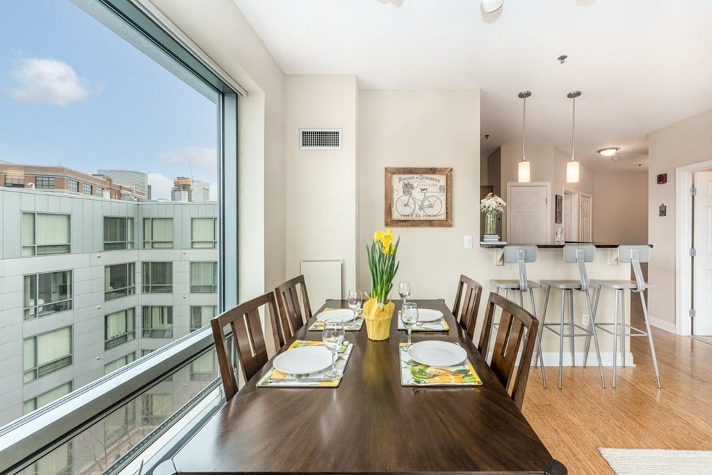 50 WB's furnished apartment showing a dining room with a large window and a table with chairs
