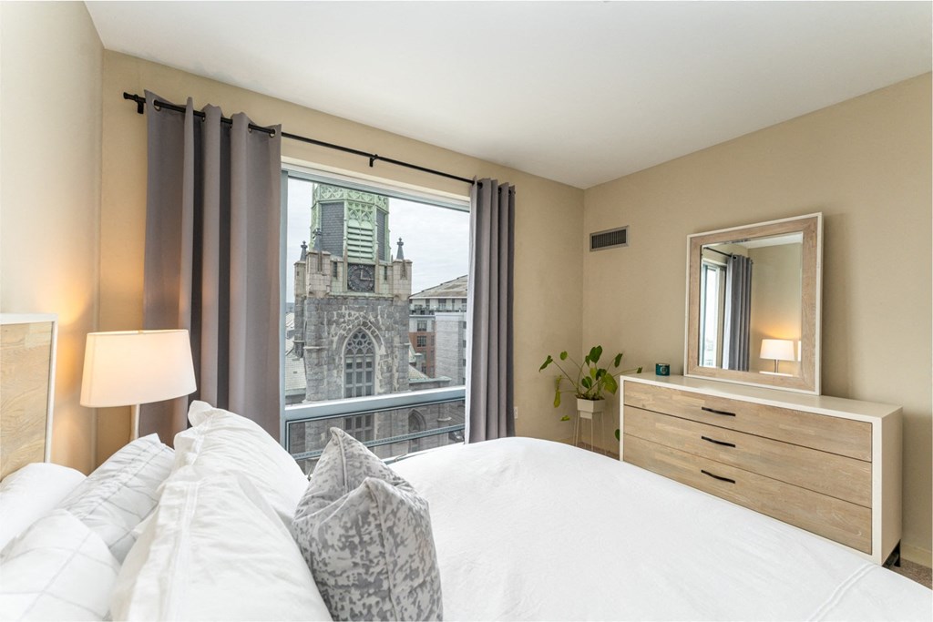 50 WB's furnished apartment showing a bedroom with a bed and a view of a church