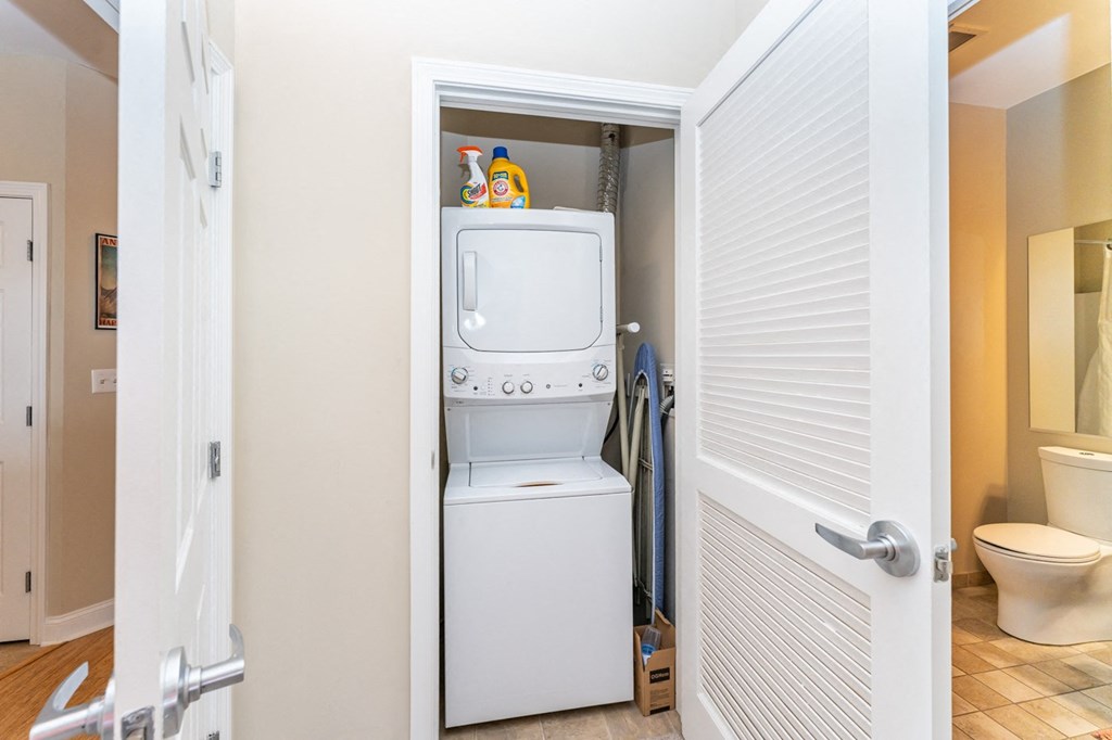 50 WB's furnished apartment showing a small laundry room with a washer and dryer in it