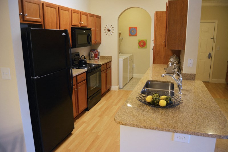 apartment kitchen with washer and dryers
