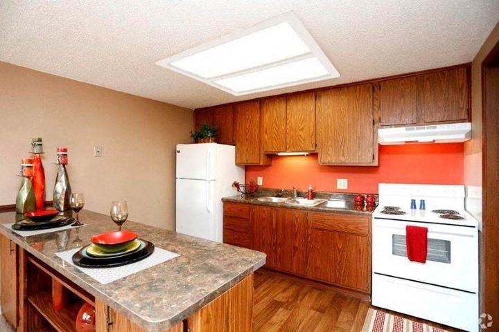 a kitchen with white appliances and a granite counter top