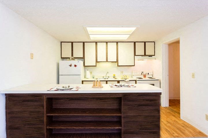a kitchen with a counter top and a refrigerator