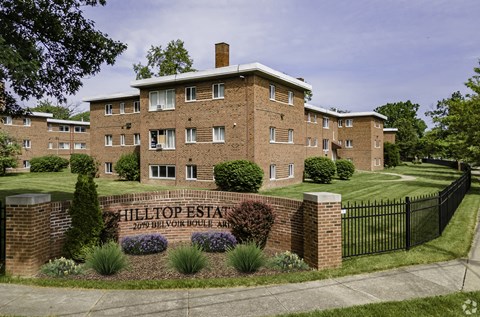 a large brick building with a black fence in front of it