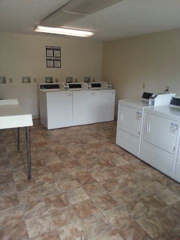 an empty room with washing machines and dryers