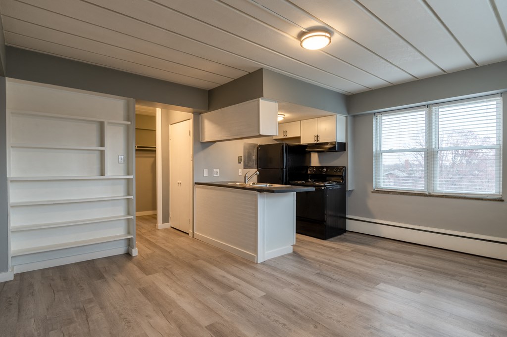 a kitchen with a island and a black stove and a refrigerator