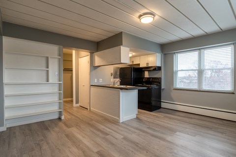 a kitchen with a island and a black stove and a refrigerator