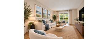 A living room with a white couch, a white chair, a coffee table, and a painting on the wall.