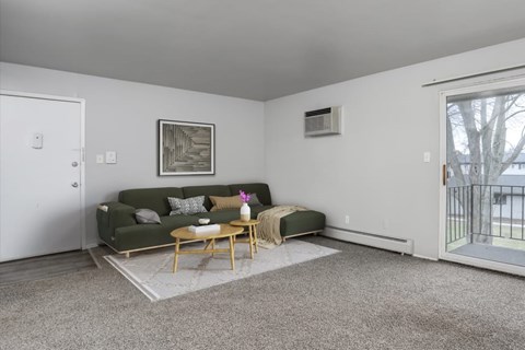 A living room with a green couch and a coffee table.