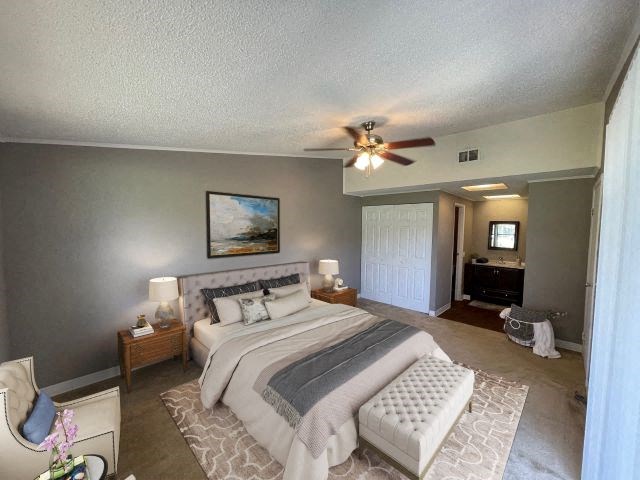 a bedroom with a bed and a ceiling fan