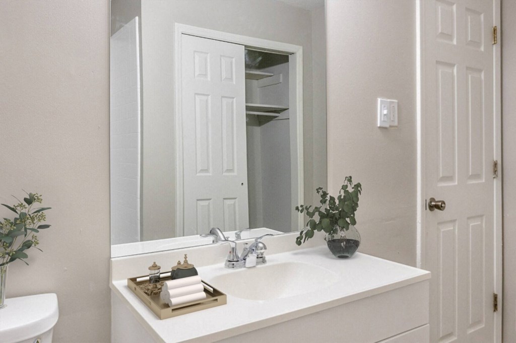 a white bathroom with a sink and a mirror