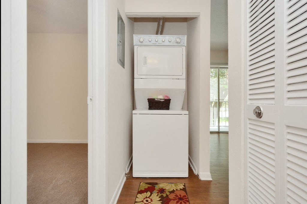 A laundry room with a washer and dryer at Aqua Bay Apartments in Naples, FL 34116