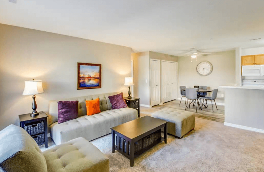 A living room with a couch, chairs, and a coffee table.