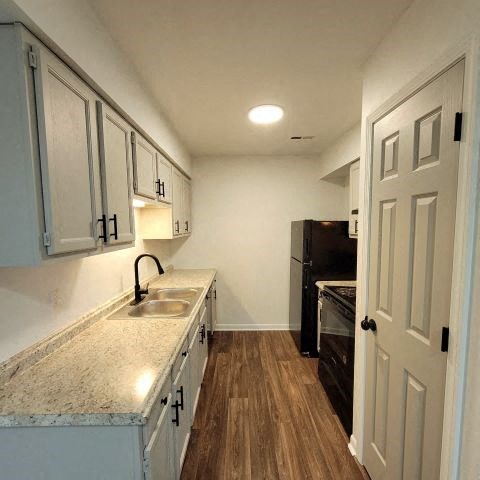 a small kitchen with a sink and a refrigerator