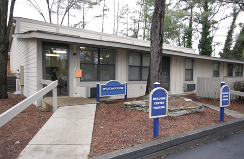 A building with a sign that says Welcome Center Parking.