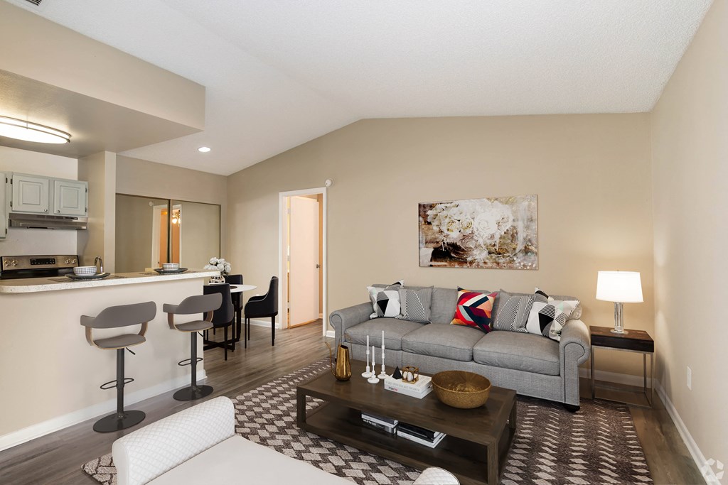 a living room with a couch and a coffee table at Aqua Bay Apartments in Naples, FL 34116