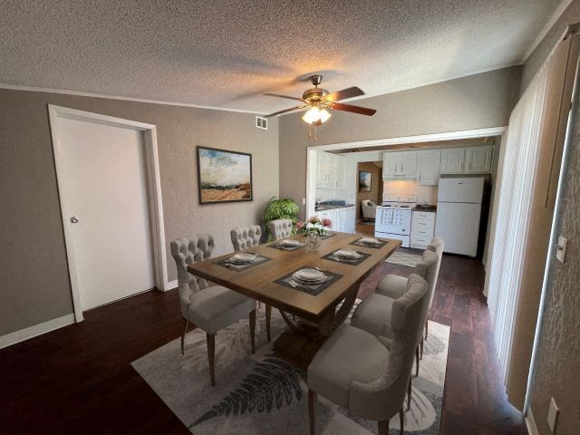 a dining room with a table and chairs and a ceiling fan