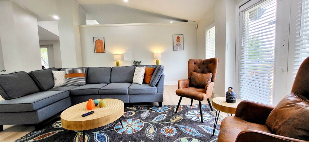 a living room with couches chairs and a rug