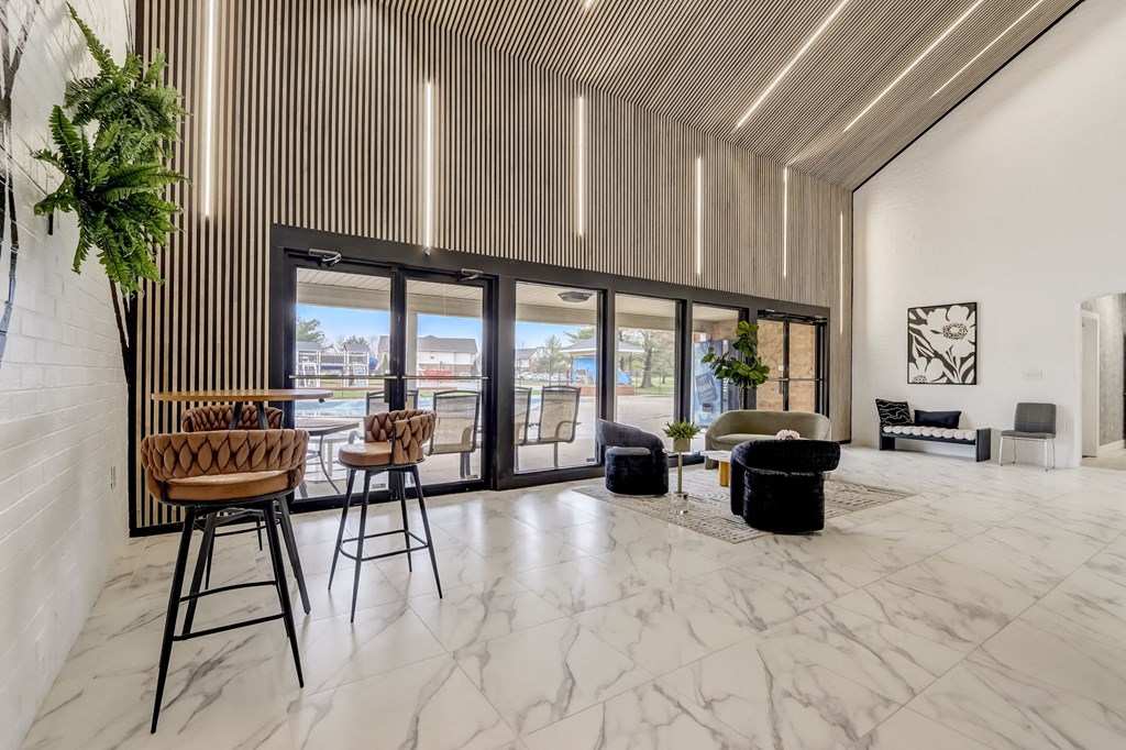 a living room with marble flooring and a table with high chairs