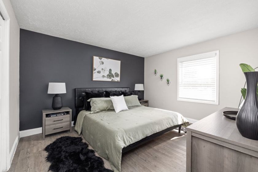 a bedroom with a bed and a dresser