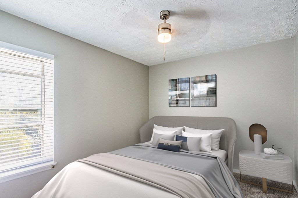 a bedroom with a large bed and a window