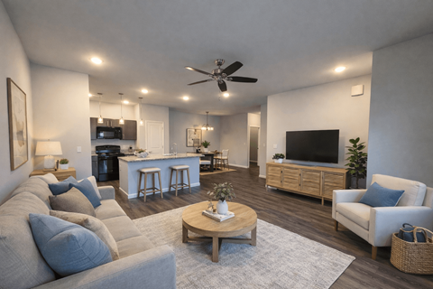 A living room with a grey couch and a wooden coffee table.