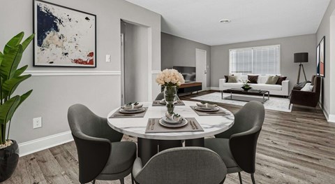 A dining room with a round table and chairs.