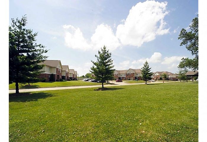 Spacious grass areas with several trees at Woodhaven Park in Indianapolis, IN. 