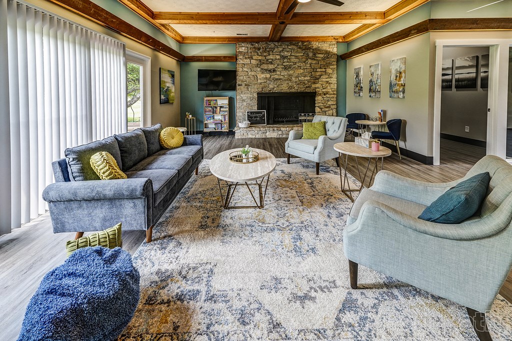 a living room with couches and chairs and a fireplace