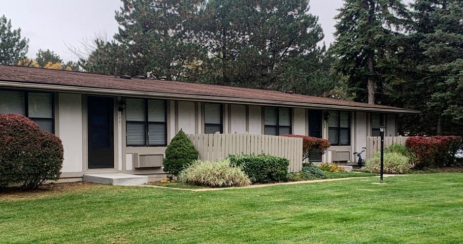 a white house with a yard and a white fence