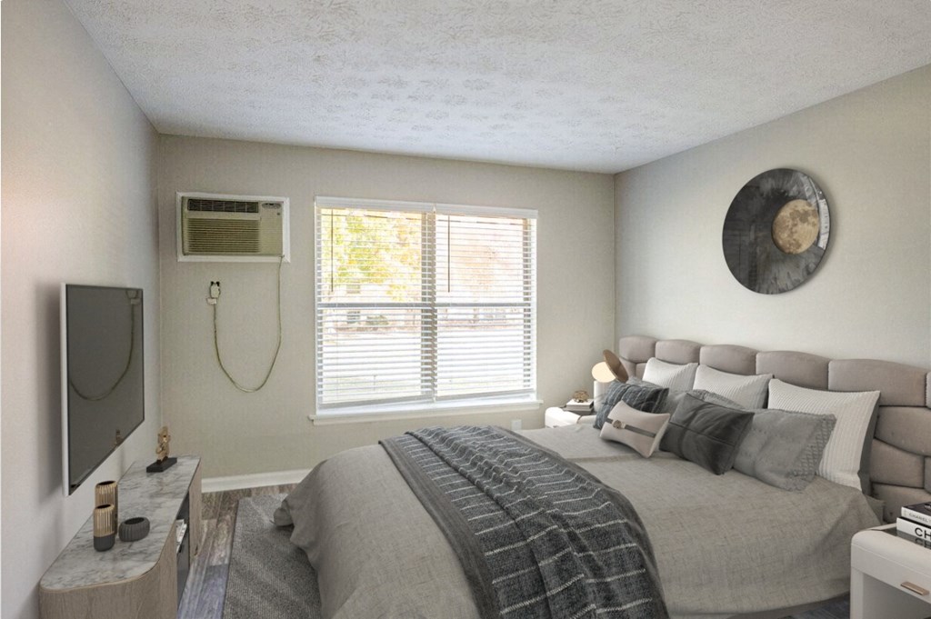 the master bedroom has a large bed and a tv