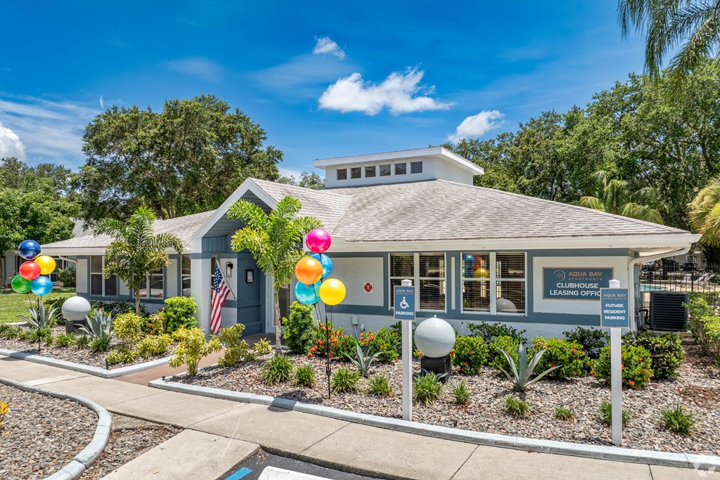 a blue building with balloons in front of it at Aqua Bay Apartments in Naples, FL 34116