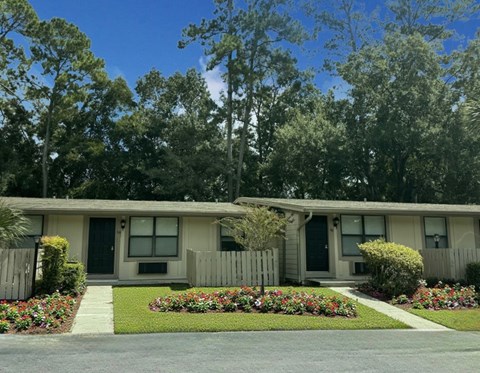 A house with a front yard and a fence.