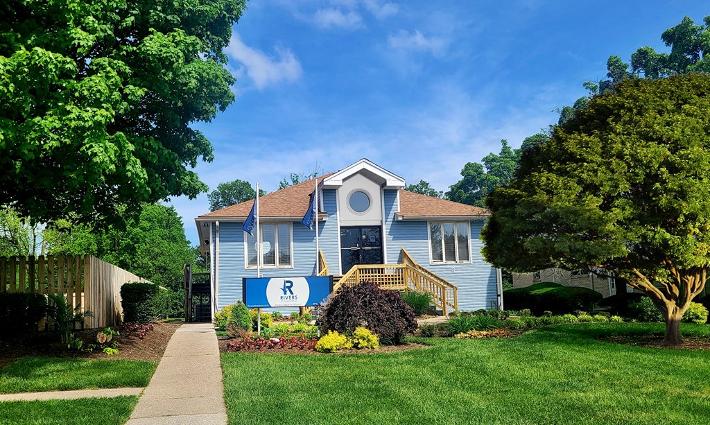 a blue house with a road sign in front of it