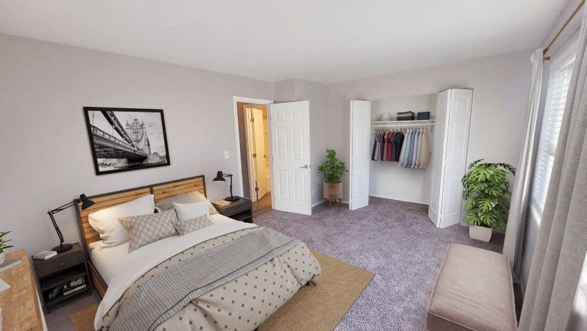 Carpeted bedroom with a bed, 2 nightstands, a closet, and a window.