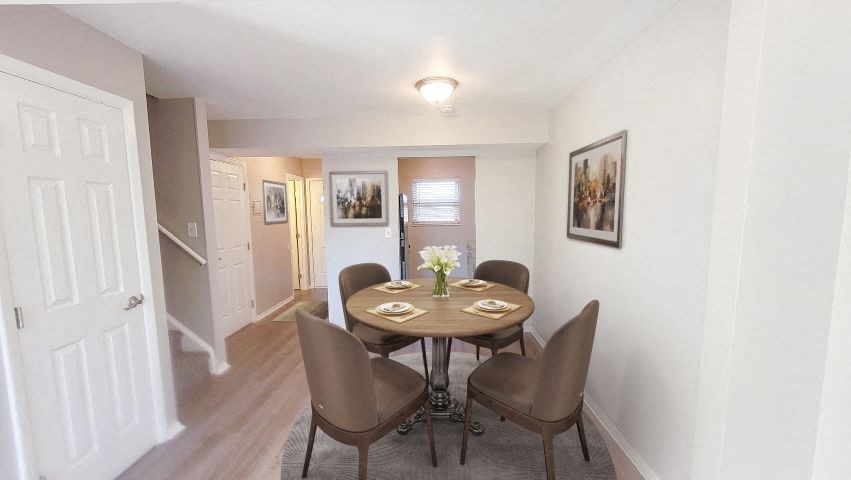 a dining room with a table and chairs