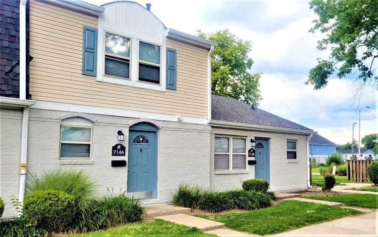 Exterior of townhomes in Indianapolis, IN with small front yards and sidewalks. 