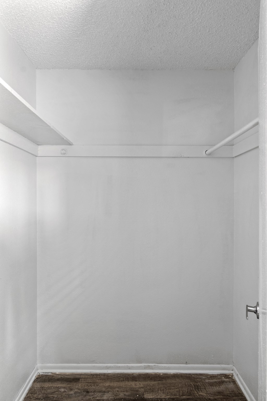 an empty room with white walls and a white door