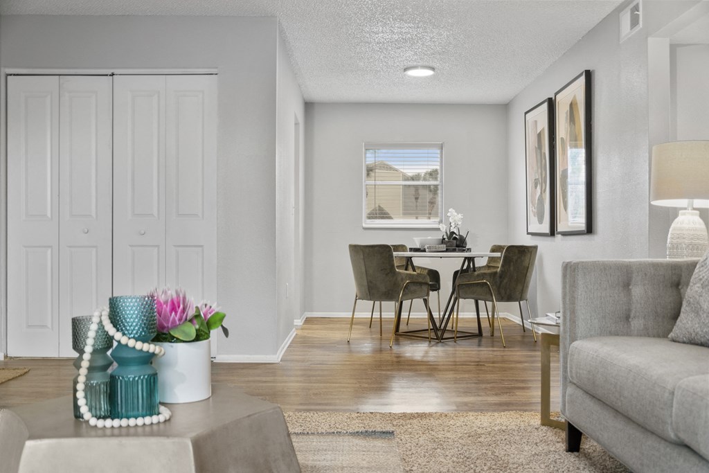 a living room and dining room with a couch and a table