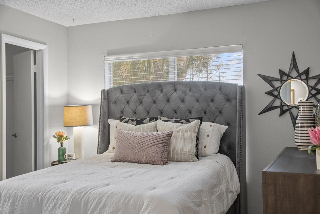 a bedroom with a large bed and a window