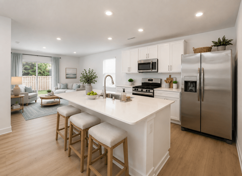 A modern kitchen with white cabinets and stainless steel appliances.